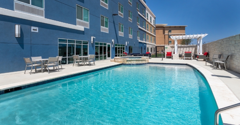 Outdoor pool and hot tub at AmericInn San Angelo