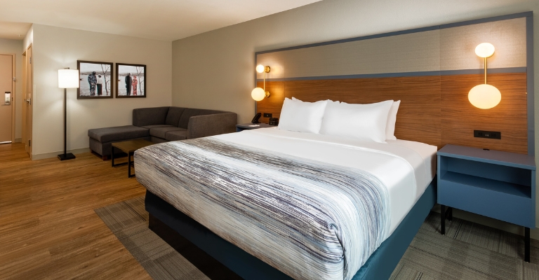 Guest room with a king bed at AmericInn San Angelo